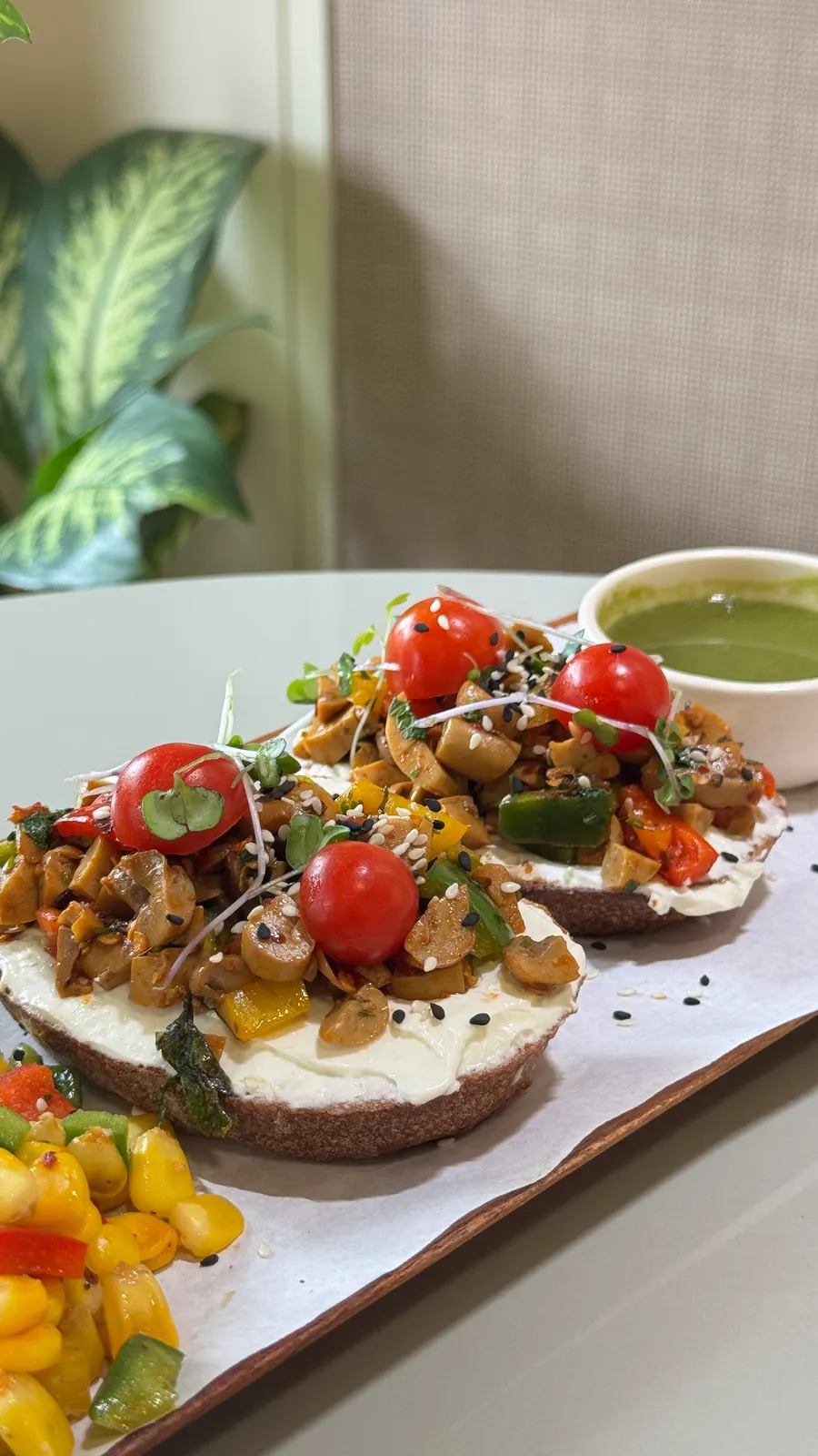 Cream cheese mushroom toast topped with cherry tomatoes and microgreens