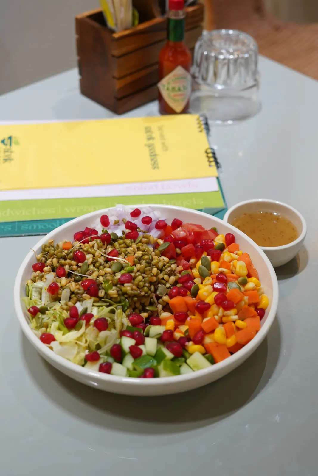 Sprout protein bowl with moong sprouts, pomegranate, carrot, cucumber and tomatoes